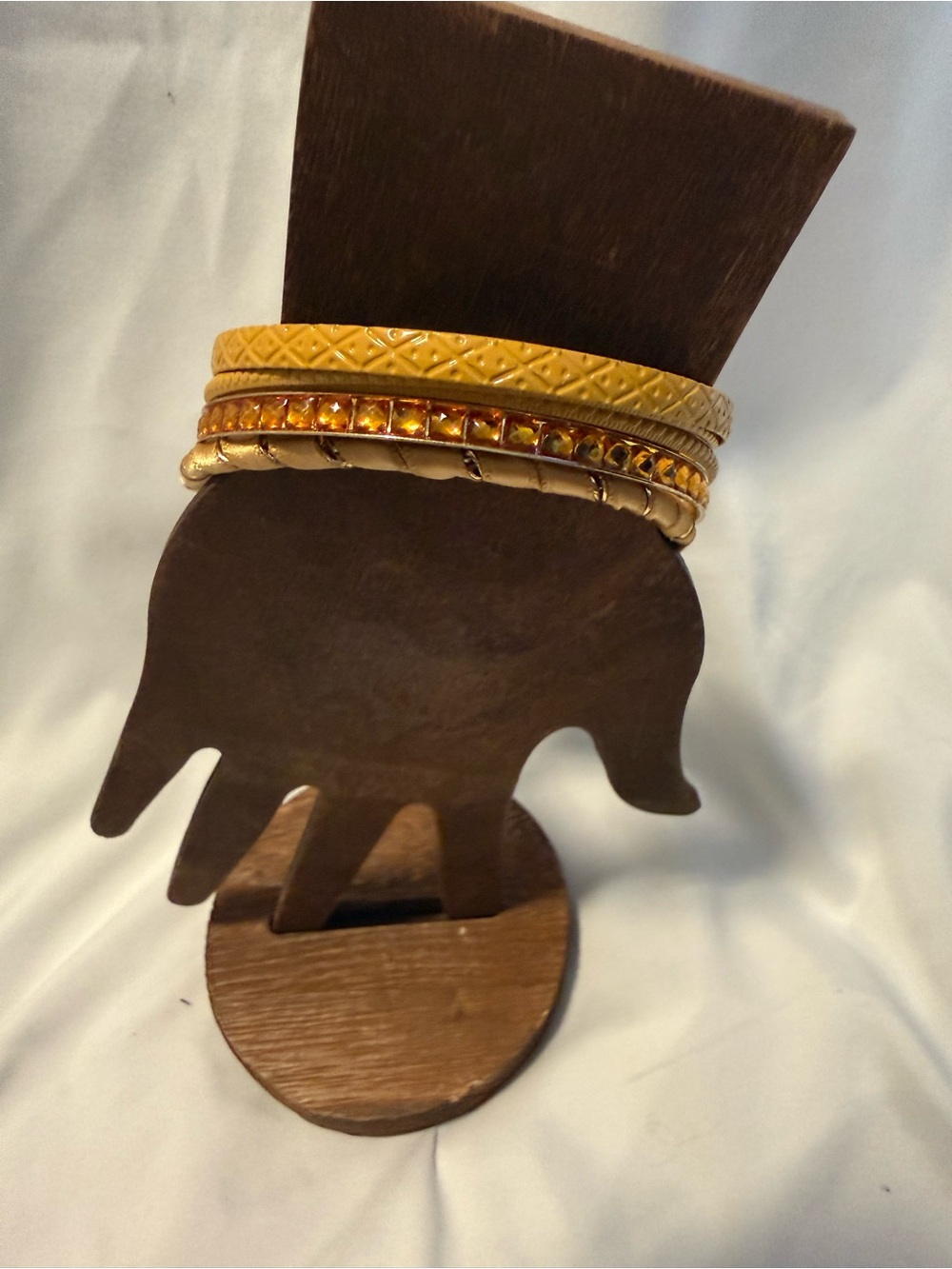 set of amber-toned bangle bracelets with gold textured detailing